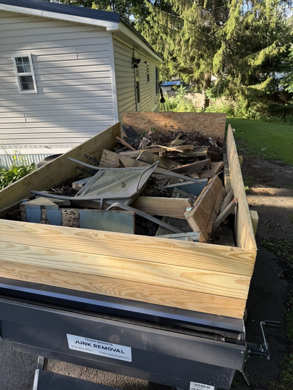 Trash Bandit crew trailer fully loaded with junk