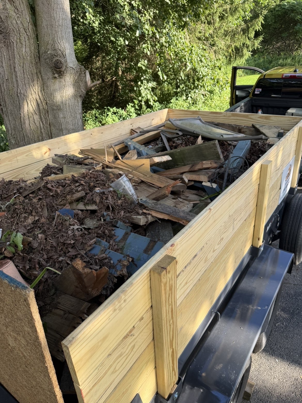 Trash Bandit trailer fully loaded for haul-away